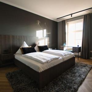 a bedroom with a large bed and a window at Landhaus Gut Halte in Papenburg