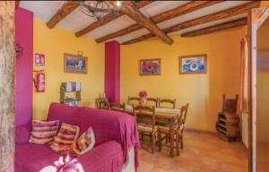 uma sala de estar com um sofá roxo e uma mesa em Casa El Limon em Gaucín
