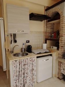 a kitchen with a sink and a counter top at La Casa dei Libri in Sutri