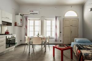 a kitchen and dining room with a table and a bed at The Beautiful Pisa in Pisa
