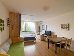 a living room with a couch and a table at Aspen studio Mountain retreat at Aspen Resort Golf Ski & Spa in Razlog