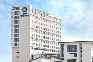 a white building with a sign on the side of it at Best Western Chatuchak in Bangkok