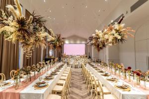 a large banquet hall with long tables and chairs at Best Western Chatuchak in Bangkok