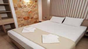Postel nebo postele na pokoji v ubytování Anastasia Luxury Suites by Xenius Zeus in Nea Flogita