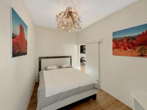um quarto com uma cama e um lustre em The Place to Be in Sion em Sião