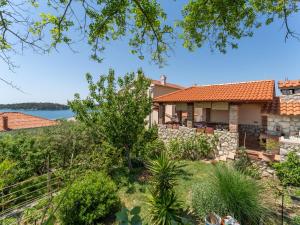 a house with a view of the water at Apartments Juric in Rab