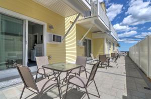 a patio with chairs and a table on the side of a building at The Inn at Sea Chambers in Ogunquit