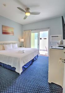 a bedroom with a bed and a sliding glass door at The Inn at Sea Chambers in Ogunquit