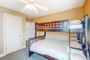 a bedroom with bunk beds and a ceiling fan at Pamlico Sunset #8-9 in Avon +30 photos