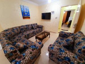 a living room with a couch and a coffee table at Miami Hotel Apartment’s in Aqaba