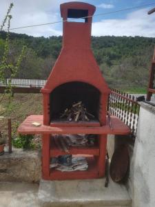 a red brick oven sitting on top of a porch at MILDA+M in Skradin