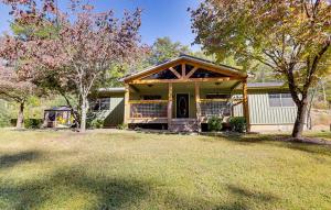 a house with a porch and a tree at Dollywood Vacation Retreat in Pigeon Forge