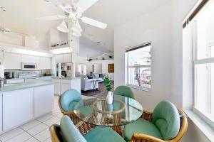 a kitchen and dining room with a glass table and chairs at Bungle House in Rotonda West