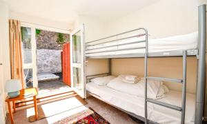 a bedroom with two bunk beds and a window at Sea Nook in Brixham