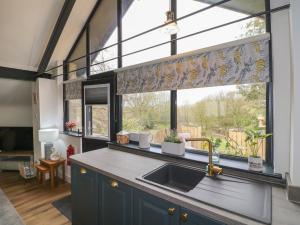 a kitchen with a sink and a large window at Stoney Rock Studio in Waterfall