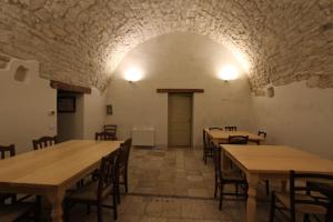 a room with wooden tables and chairs in a building at Scardalano Resort in Morcone