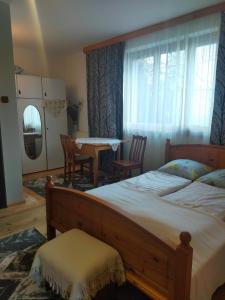 a bedroom with a large bed and a table and chairs at cicha przystan in Połczyn-Zdrój