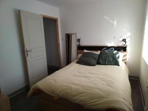 a bedroom with a large bed with two pillows at Duplex Tressange in Tressange