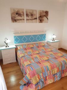 a bedroom with a bed and two night stands at sweet home la maddalena in La Maddalena