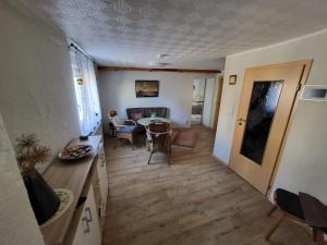 a kitchen and living room with a table and chairs at Ferienwohnung Haus Luzia in Düngenheim