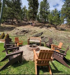 a group of picnic tables and benches in a park at Allen Gulch Cabins in Hill City