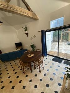 een woonkamer met een tafel en een bank bij Maison - Ancien Chai in Turquant