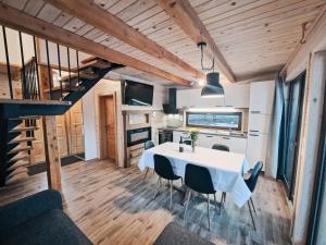 a kitchen and dining room with a table and chairs at HIŠA ZIMAZAKON BLOKE in Nova Vas