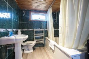 a bathroom with a sink and a toilet and a window at Beautiful Rooms in Edinburgh Cottage Guest House - Free Parking in Edinburgh +67 photos