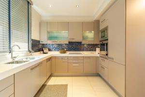 a kitchen with white cabinets and a sink at Something different in Chalkida in Chalkida