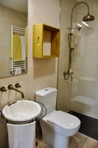 a bathroom with a toilet and a sink and a shower at New Honey House, Serra do Marão Ansiães-Amarante in Amarante