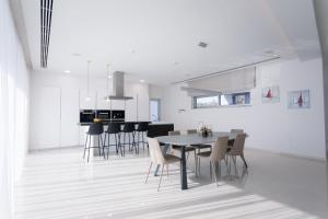 a kitchen and dining room with a table and chairs at Sea Pearl Beachfront Villas - Anemone in Ayia Napa