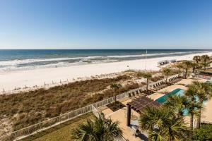 a view of the beach from the balcony of a resort at Ocean Villa 406 in Panama City Beach