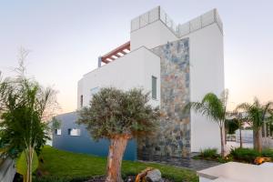 a house with a cross on the side of it at Sea Pearl Beachfront Villas - Anemone in Ayia Napa