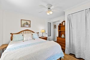 a bedroom with a bed and a ceiling fan at Delight on Davis in Atlantic Beach