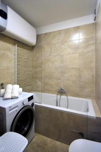 a washing machine in a bathroom with a tub at Apartment Nikola in Split