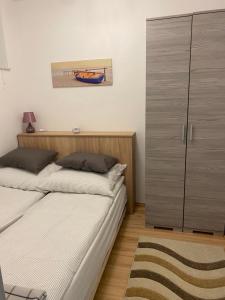 1 dormitorio con 2 camas y armario en Belu Apartman en Balatonlelle