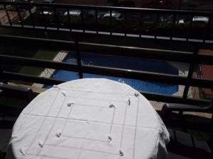 a table with a white cover on top of a net at Inviting apartment in Torremolinos with shared pool in Torremolinos