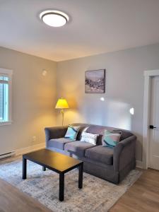 a living room with a couch and a coffee table at Feel like Home! in Langford