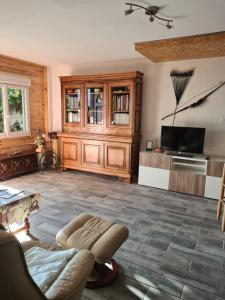 a living room with a couch and a tv at Appartement en bois in Sète