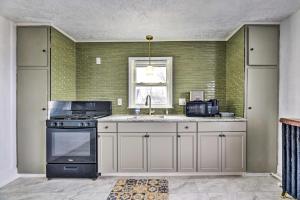 a kitchen with a sink and a stove at Vacation Rental about 2 Mi to Highmark Stadium! in Buffalo