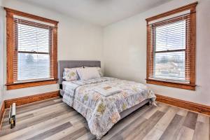 a bedroom with a bed and two windows at Vacation Rental about 2 Mi to Highmark Stadium! in Buffalo