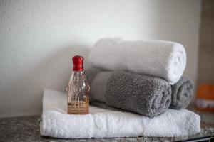 a bottle of alcohol sitting on a pile of towels at Four Points in Vir +160 photos