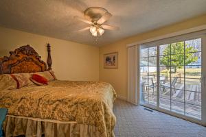 a bedroom with a bed with a ceiling fan and a window at Serene Blue Ridge Getaway in Galax with Yard! in Galax
