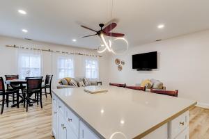 a kitchen and living room with a ceiling fan at Savannah Serenade - Suite D in Savannah