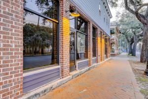 a brick building with windows on a street at Savannah Serenade - Suite D in Savannah