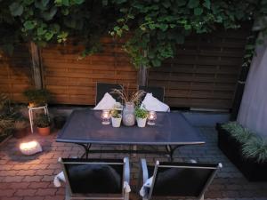 a table with plants and candles on a patio at U Miśków in Pobierowo