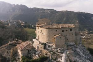 an old building on top of a mountain at Castel Di Luco - Authentic 11th-Century Castle in Acquasanta Terme