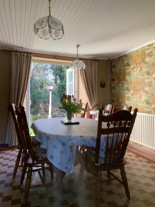 a dining room table with a vase of flowers on it at Tullyard House 