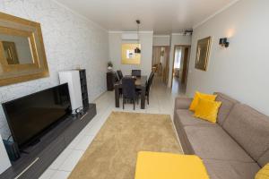 a living room with a couch and a table at Holiday Albufeira in Albufeira