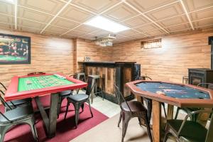 a room with two ping pong tables and chairs at Blue Mountain Lake Pocono House in East Stroudsburg